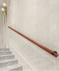 Natural Wooden Wall Mounted Porch Railing Adjustable Deck Handrail on a stair wall, providing heavy duty support and grip.