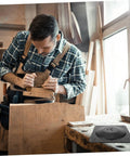 Woodworker using Heavy Duty Table Leg Brackets And Furniture Connector Plates Built Ridiculously Sturdy With Rock Solid Iron Mounting Design For Modern Diy Home Decor Quick Setup No Sweat Assembly Hardware in workshop.
