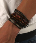 Handcrafted Hemp Cord And Genuine Leather Bracelet With Rustic Wooden Beads Adjustable Unisex Chain shown on wrist.