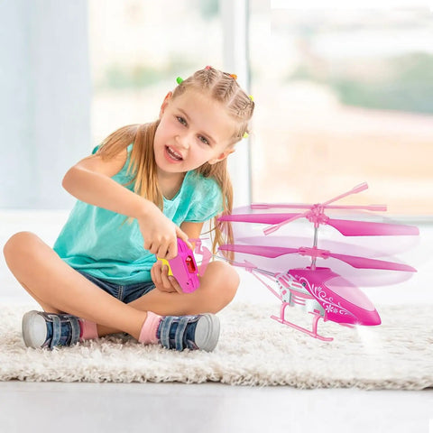 Girl playing with Pink RC Helicopter For Kids And Beginners 2.4GHz 3.5 Channel Indoor Flight Toy With LED Lights Easy To Fly Gift