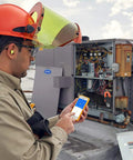 Technician using Smart TRMS 6000 Counts Clamp Meter With App Hookup For Android And iOS Digital Clamp On Ammeter in field work