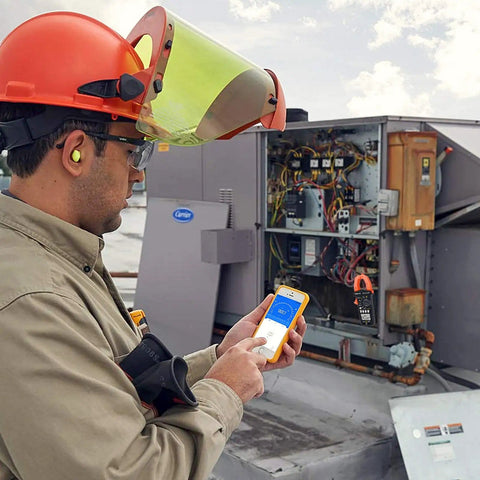 Technician using Smart TRMS 6000 Counts Clamp Meter With App Hookup For Android And iOS Digital Clamp On Ammeter in field work