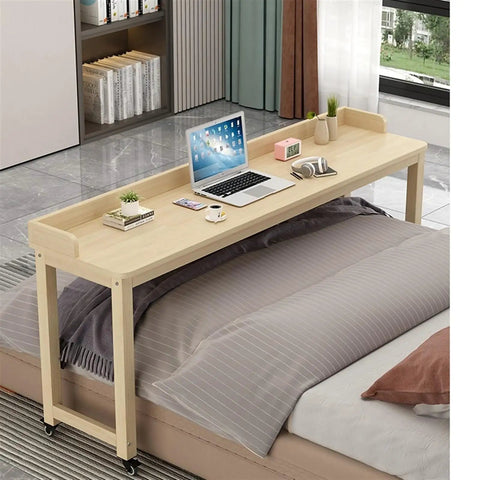 Roomy Rollin Overbed Laptop Desk Featuring Sturdy Guard Rail And Smooth Lockable Wheels Solid Wood Bedside Tray on bed with laptop.