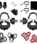 Dual Sensing Pedal Based Power Meter with extra cleats, charger, cables, and rubber covers for road cycling connectivity.