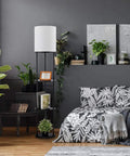 Versailles Floor Lamp With Built-In Shelves, 57.5 Inch Matte Black, White Linen Shade beside bed in modern room setting
