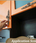 Person installing Antique Floral Cabinet Handles Set For Kitchen Cabinets, Bronze Vintage Door Pulls on orange cabinet