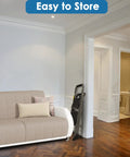 Two Step Folding Ladder With Wide Anti Slip Pedals And Comfort Handle lightweight steel stored beside a sofa in a living room
