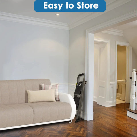Two Step Folding Ladder With Wide Anti Slip Pedals And Comfort Handle lightweight steel stored beside a sofa in a living room