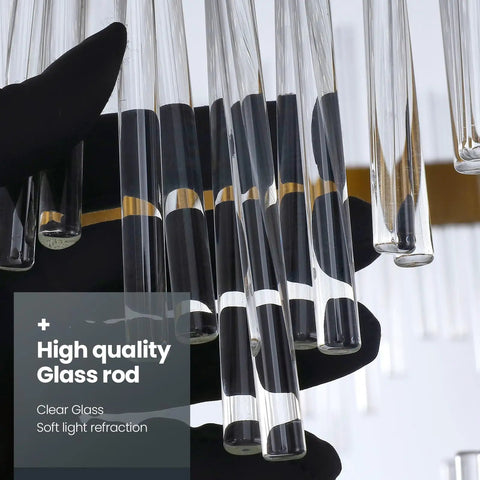 Close-up of sleek glass rods on a gold crystal wall sconce with modern vibe, stainless steel base, held in gloved hand.