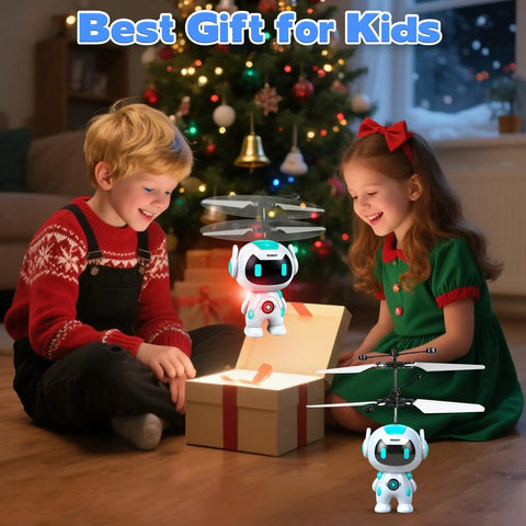 Children playing with Hand Operated Flying Ball Drone With Led Lights Indoor Rechargeable Mini Helicopter Toy beside a Christmas tree.