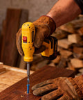 Person using a drill with Blue Concrete Screws Kit With Drill Bit And Driver, securing wood on a workbench.