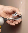 Using drill to install 20 Pack Lighting Conduit Hangers For One And A Half Inch Galvanized Conduit Clamps on wall