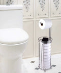 Freestanding Toilet Paper Roll Holder Stand Dispenser with Built In Storage Shelf in stainless steel next to a toilet in a bathroom