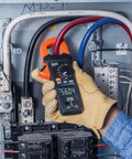 Electrician using Digital Clamp Meter With True RMS And LoZ Auto Ranging For AC And DC Voltage And Current in electrical panel