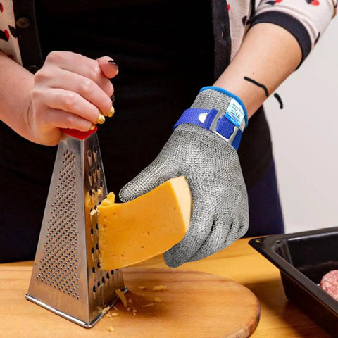 Person grating cheese with Cut Resistant Kitchen Gloves With Stainless Steel Mesh For Oyster Shucking And Meat And Fish Prep