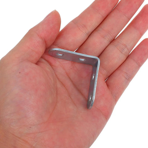 Hand holding a stainless steel bracket from 16 Piece Heavy Duty L Bracket Corner Brace Kit For Tables And Cabinets With Screws