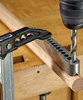 Universal V-Drill Guide For Perpendicular Hole Drilling On Flat Round And Square Materials clamped on wooden rod