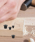 Close-up of 8 Piece Woodworking Dowel Pin Locator Kit with Metal Center Transfer Plugs on wooden surface for precise alignment