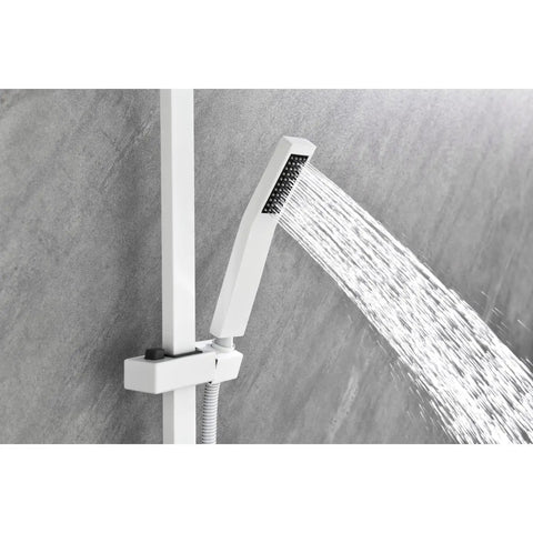 Hand shower of the Wall Mounted Waterfall Shower System with Hand Shower sprays water against a gray tiled wall.
