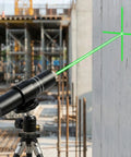 Three Head Green Laser Level Kit With Rechargeable Battery projecting cross and linear lasers on construction site wall.