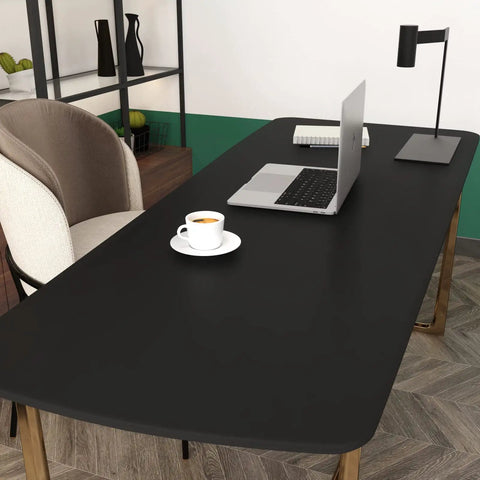 Office desk covered with Matte Black Peel And Stick Wallpaper Self Adhesive Waterproof Countertop Paper For Cabinets And Walls Thick Renter Friendly Cover Sticks Easy With Knife And Rag 15.8 x 196 Inches (21.5 Sq Ft) For Kitchen Bedroom Living Room Camper, laptop, lamp, and coffee cup visible.