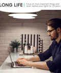 Bright A21 LED Bulbs 150 Watt Equivalent Pack providing crisp daylight-style light above person at laptop