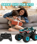 Child opening a gift on a couch with the All Terrain Dinosaur Monster Truck RC Car With 2.4Ghz Remote beside them.