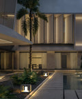 Night view of modern house with No Wiring Needed Solar Post Light For Outdoors, illuminating pathway in stainless steel fixture.