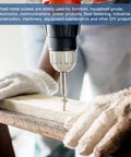 Person using drill to install sheet metal screw in wood, wearing protective gloves, focusing on DIY and construction projects.