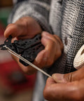 Using Suspension NXT 15 In 1 EDC Multitool With Needle Nose Pliers to cut a rope during camping or survival activity.