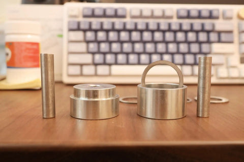 Coin Ring Puncher and Spacer Set for Jewelry Making with Six Spacer Rings in Inner Diameters of 1.362, 1.276, 1.228 on desk.