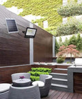 JUDYSSY Creative Ip67 Waterproof 108 LEDs 60W Solar Security Lights on a patio area with outdoor seating.