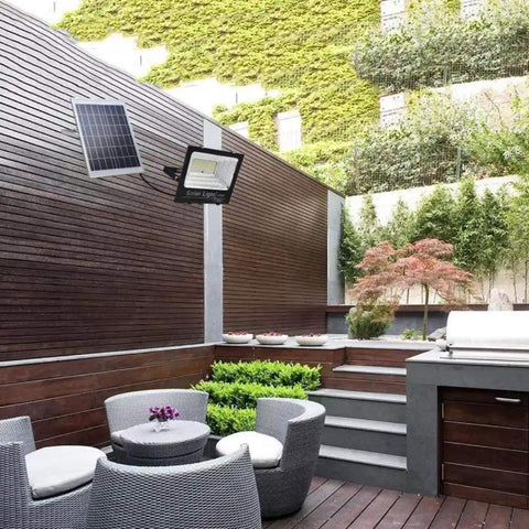 JUDYSSY Creative Ip67 Waterproof 108 LEDs 60W Solar Security Lights on a patio area with outdoor seating.