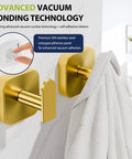 Heavy Duty Self Adhesive Wall Hooks Built Different, Stainless Steel Sticky Towel Holder With Knockout Grip For Bathroom Shower Or Kitchen, Hang Heavy Coats Without A Sweat, Gold Finish, 2 Pack on a wall with a towel hanging.