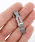 Top Shelf 13 Piece Titanium Screw Kit For Benchmade Bugout 535 Repair With T10 Torx Pivot Bolts And T6 Body Fasteners, titanium clip held in hand.