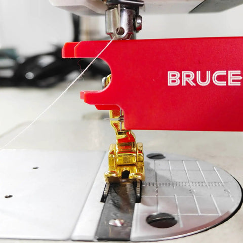 Close-up of sewing machine using Four In One Automatic Needle Threader With Quick Threading Magnifier Lens Magnetic Guide And Two Seam Rippers