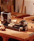 Mini Benchtop Wood Lathe Machine 20000 RPM Precision Turning Tool for STEM Education on a workbench with wood crafts