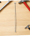 Four Piece Round Heat Sealer Heating Wire Replacement Strips for Manual Shrink Wrap Bag Sealer on wooden surface with tools.