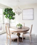 Farmhouse 5 Light French Country Wood Chandelier For Dining Room And Kitchen Island in bright dining space.