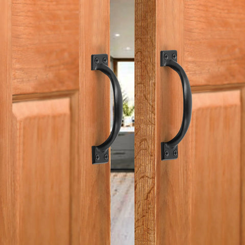 4 Inch Black Iron Cabinet Pulls Pack Of 2 With Ergonomic Grip installed on wooden doors, showcasing the vintage rustic style and matte black finish.