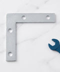 L Shape Metal Corner Brackets 100 Pcs 2.17 By 2.17 Inch Silver Iron Frame Supports for shelves with wrench on marble surface