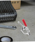 A single horizontal clamp of the Four Piece Push Pull Toggle Clamps Set for Woodworking and Metal Workholding on a workbench.