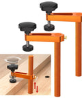 Pro Grade Adjustable Height Bench Clamp For Woodworking Fits Three Quarter Inch Dog Holes Aluminum Alloy Holdfast Stable Hold Two Pack Durable Clamp Set With Flexible Positioning And Rock Solid Grip On Any Workbench showing dual clamps and flexible positioning on wood surface.