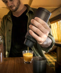 Portable Espresso Maker For Ground Coffee And NS Capsules, 20 Bar Pressure, Dark Burgundy in use on table