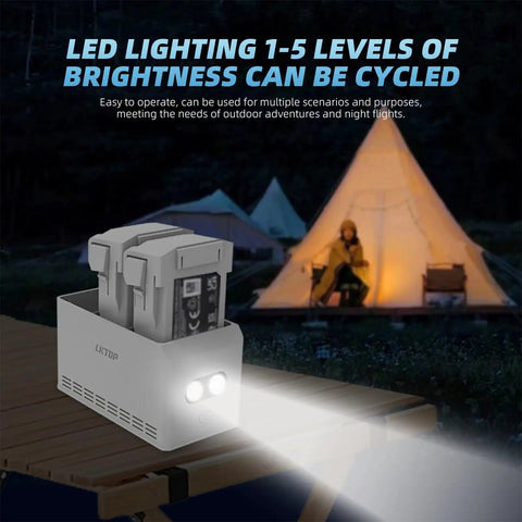 Two Way Charging Hub For DJI Mini 3 And Mini 4 Pro Drones Fast 37W Power Charges Three Batteries At Once Safe Temperature Controlled Smart Charging With LED Brightness Levels on a wooden table outdoors by a tent.