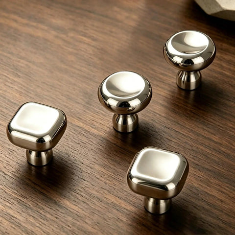 Slick Silver Cabinet Knobs and Drawer Pulls Set, Polished Zinc Alloy With Titanium Coating on wooden surface