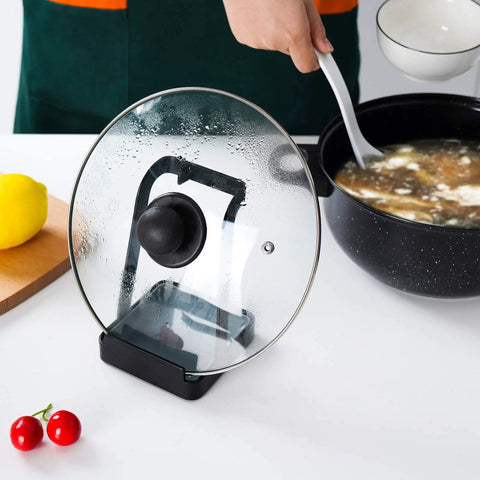Hella Convenient Multi Function Kitchen Utensil And Pot Lid Organizer Pad With Spoon Rest Ladle Holder Catch Mat Drip Tray Washable Heavy Duty Stick Mount Black, showing glass lid rack with pot.