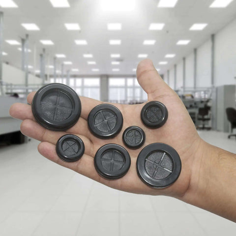 Hand holding 52 Piece Rubber Grommets Kit With Firewall Hole Plugs In Six Hole Sizes for wire protection and automotive repair