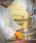 Person wearing Outrageous Orange Heavy Duty Disposable Nitrile Gloves 8 Mil Latex Free Powder Free in a food prep area.