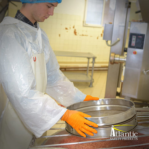 Person wearing Outrageous Orange Heavy Duty Disposable Nitrile Gloves 8 Mil Latex Free Powder Free in a food prep area.